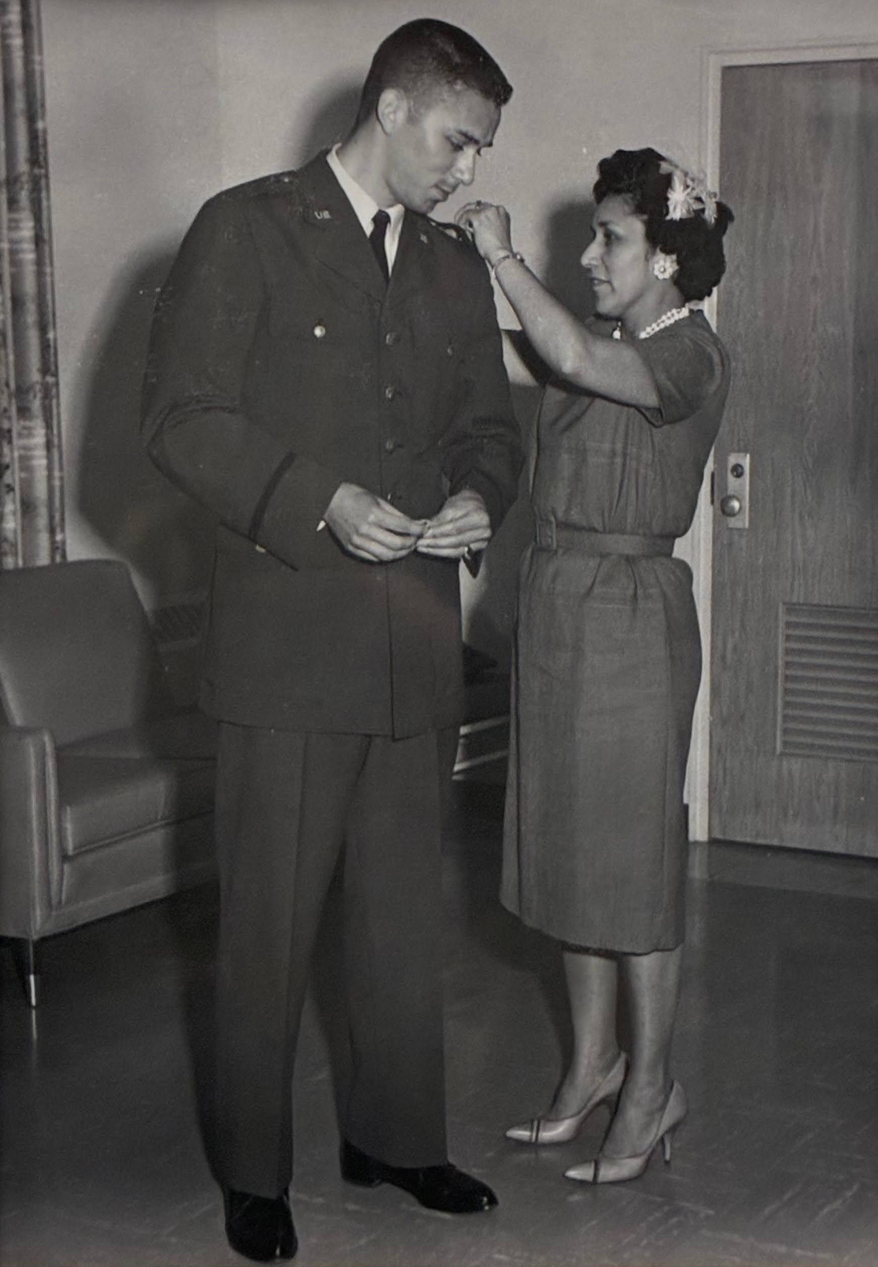 Vintage photo of woman adjusting military uniform, formal dress, historic military fashion