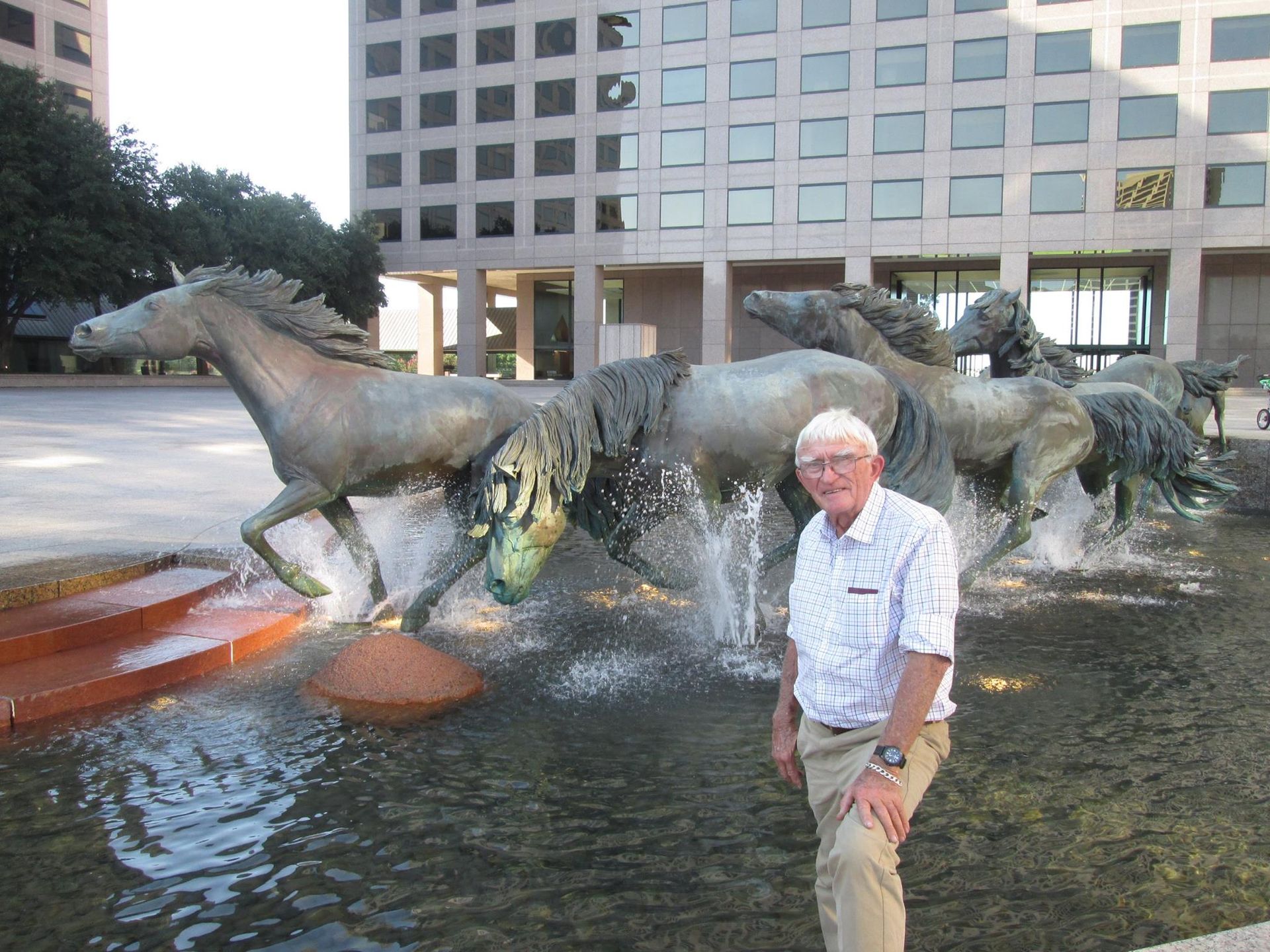 Robert Glen beside the mustangs