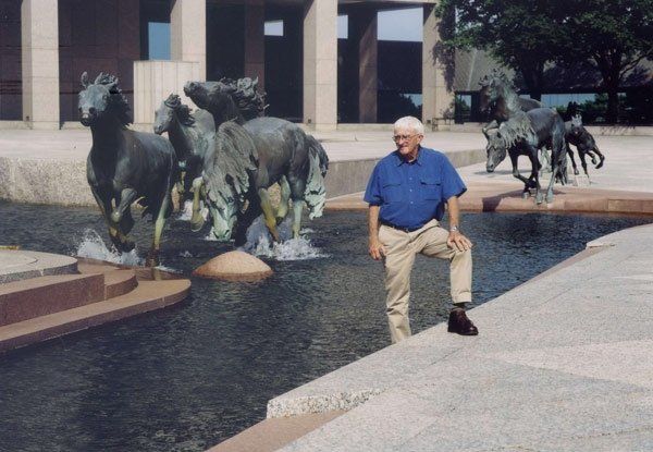 Robert Glen beside the mustangs