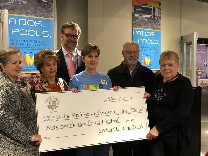 Six adults with an oversized check for $42,300 from Irving Heritage Festival to Irving Archives and Museum.