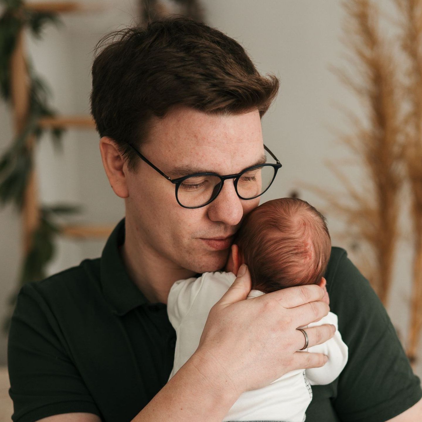 Neugeborenes Baby an des Vaters Brust
