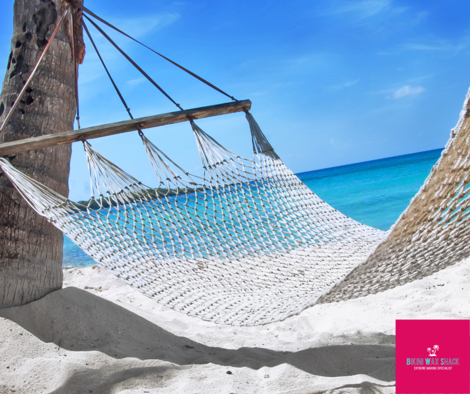 Empty hammock on a an empty beach
