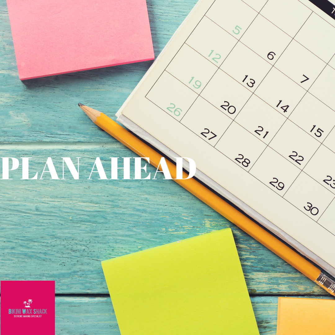 open calendar with post it notes and a pen, slogan reads plan ahead