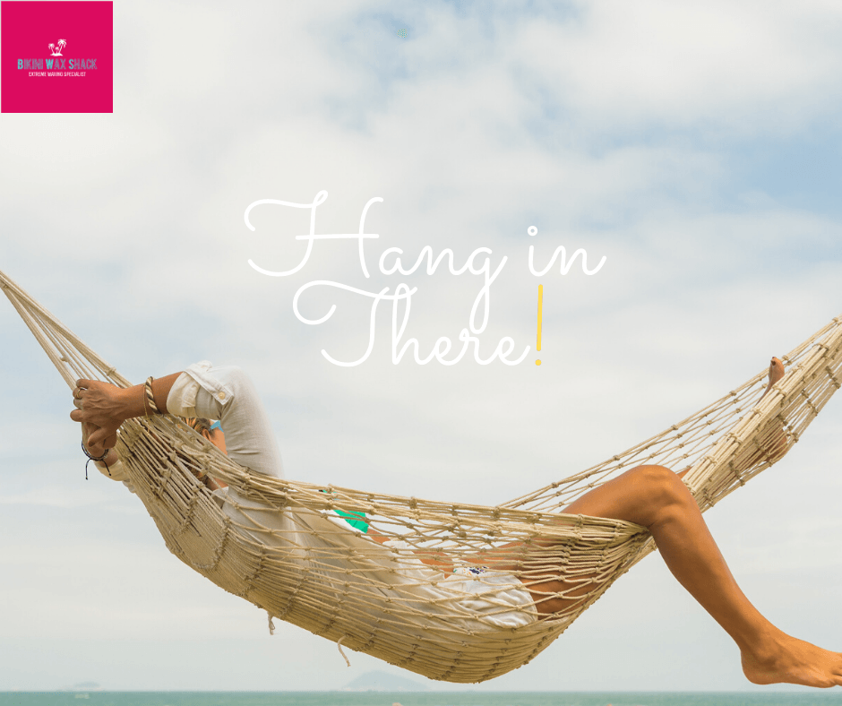 Relaxing in a hammock with slogan hang in there