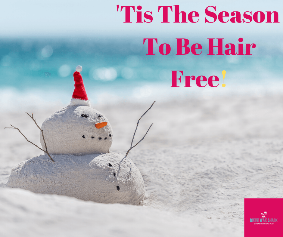 sand snowman on a beach with slogan 'tis the season to be hairfree