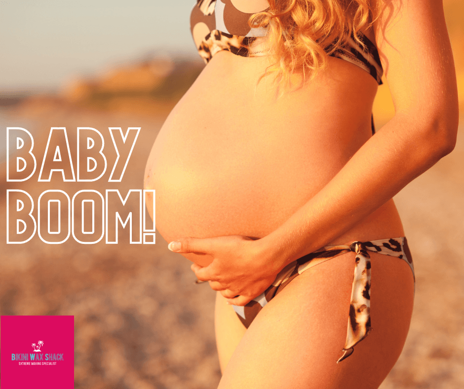 pregnant lady on a beach in a bikini