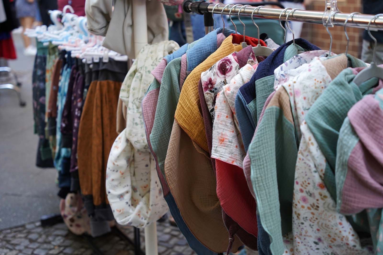 Paulinchen Kids: dargestellt ist hübscheste Kinderkleidung aus erster und zweiter Hand auf Kleiderständern.