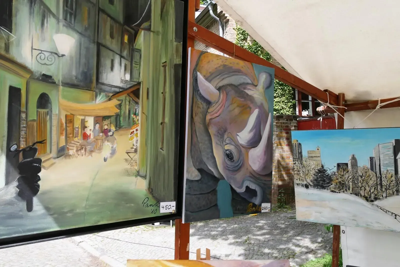 Bilderausstellung mit Stadtmotiv, Rhinozeros-Porträt und Winterlandschaft bei KUNST trifft WEIN am Dorfteich Lichtenrade