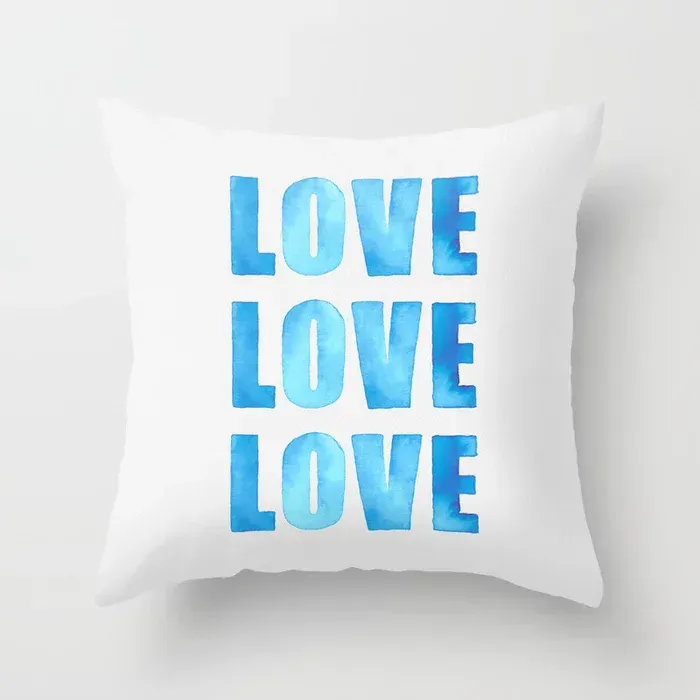 pillow with hand-painted watercolor letters, spelling out Love Love Love