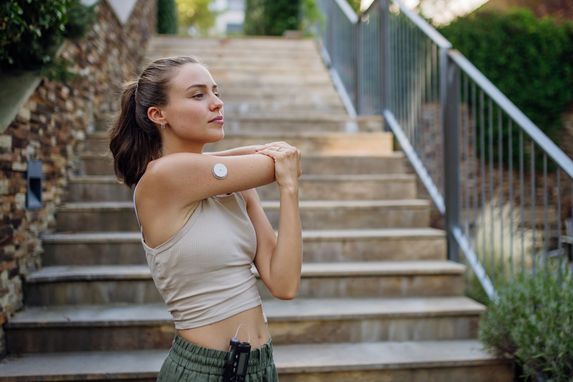 Woman doing exercise wearing diabetes monitor