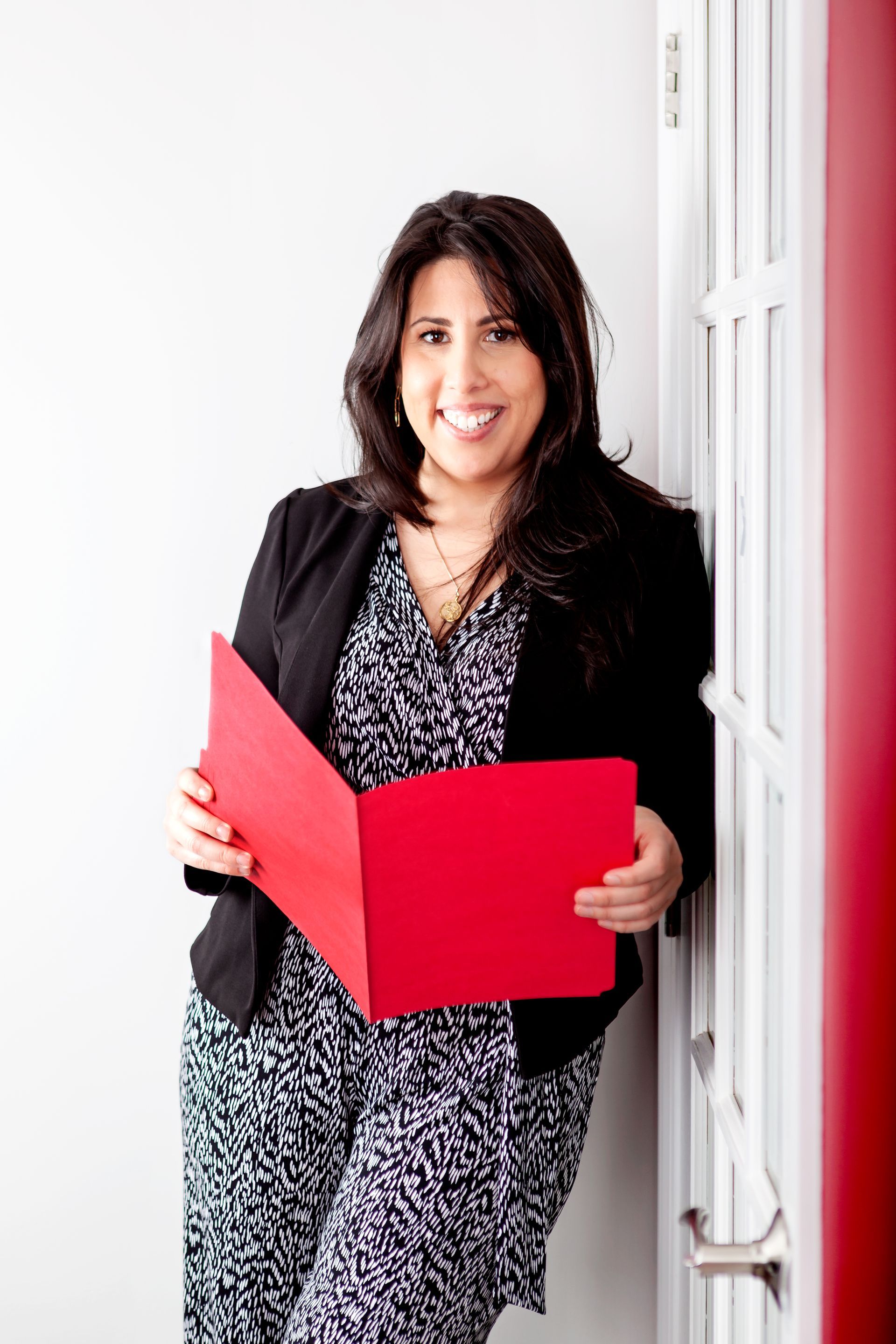 A FullForce Team member holding a file folder at the office