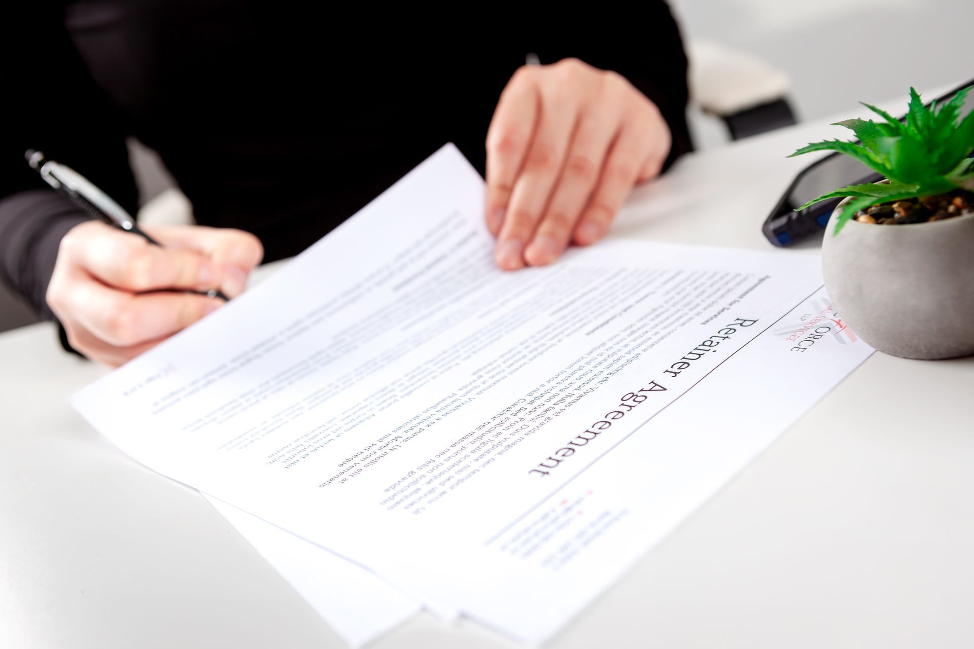 A member of the FullForce Team signing a legal document