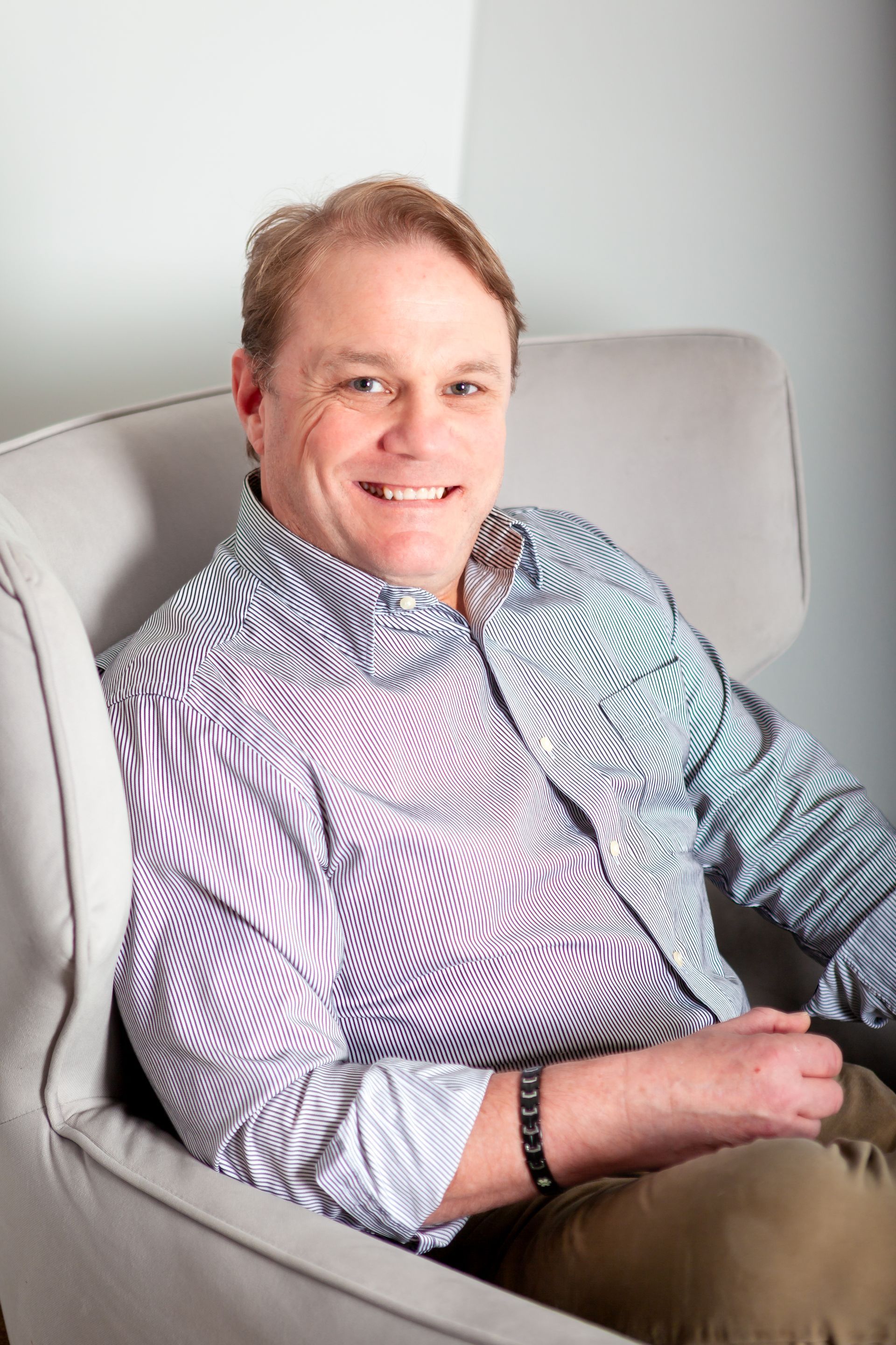 Rodney Jackson Sitting in a chair in his office smiling