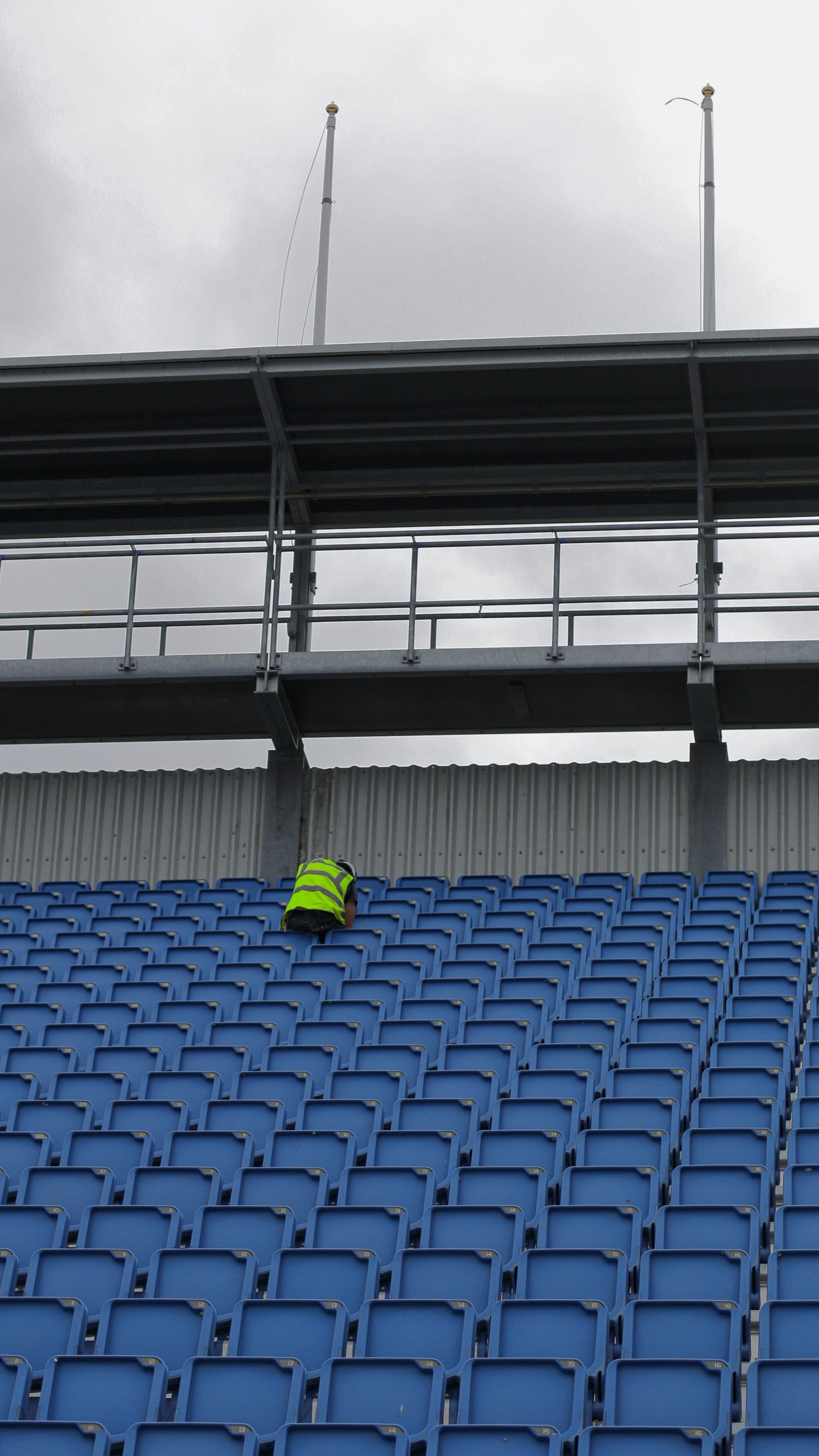 Agent d'entretien qui nettoie les gradins d'un stade