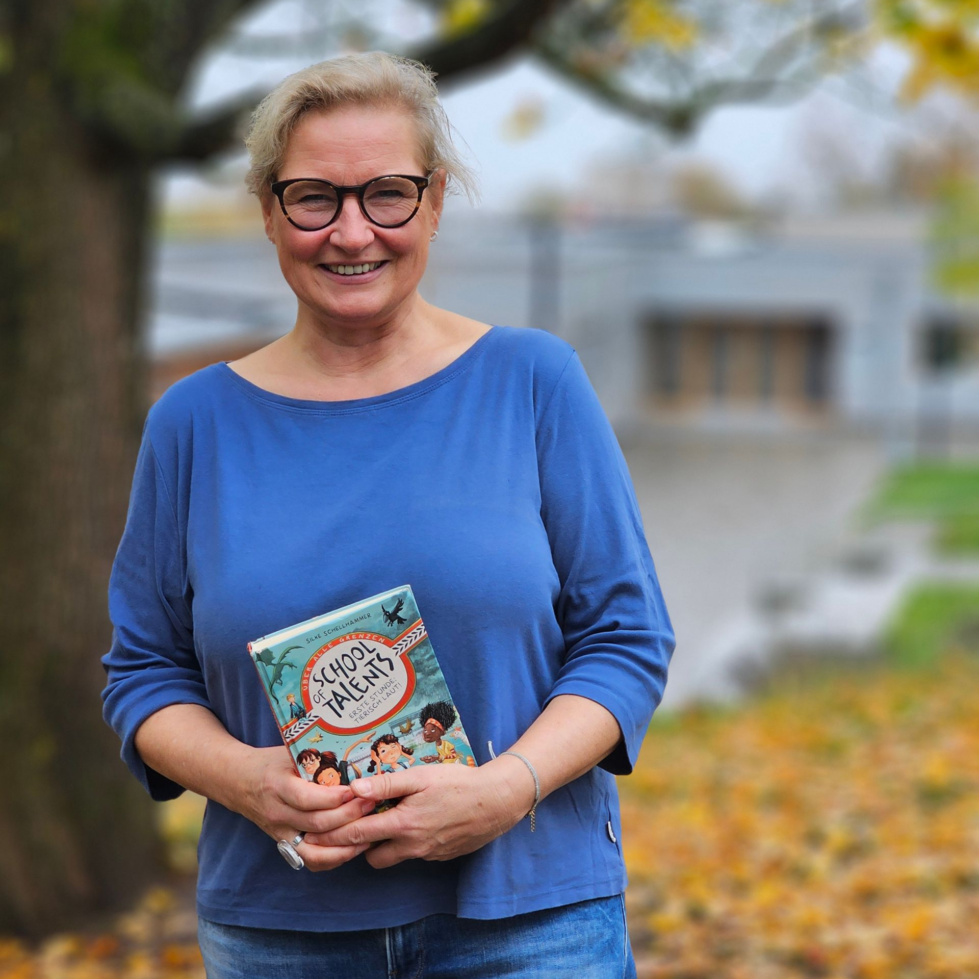 Autorin Silke Schellhammer mit ihrem Buch vor der Otfried-Preußler-Schule