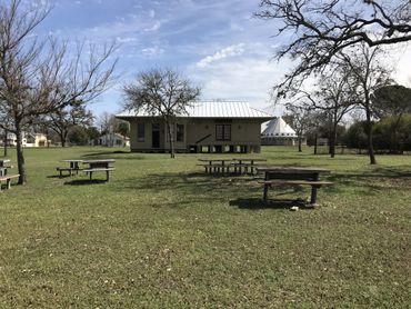 Center Point Heritage Park with tables and old train depot in back