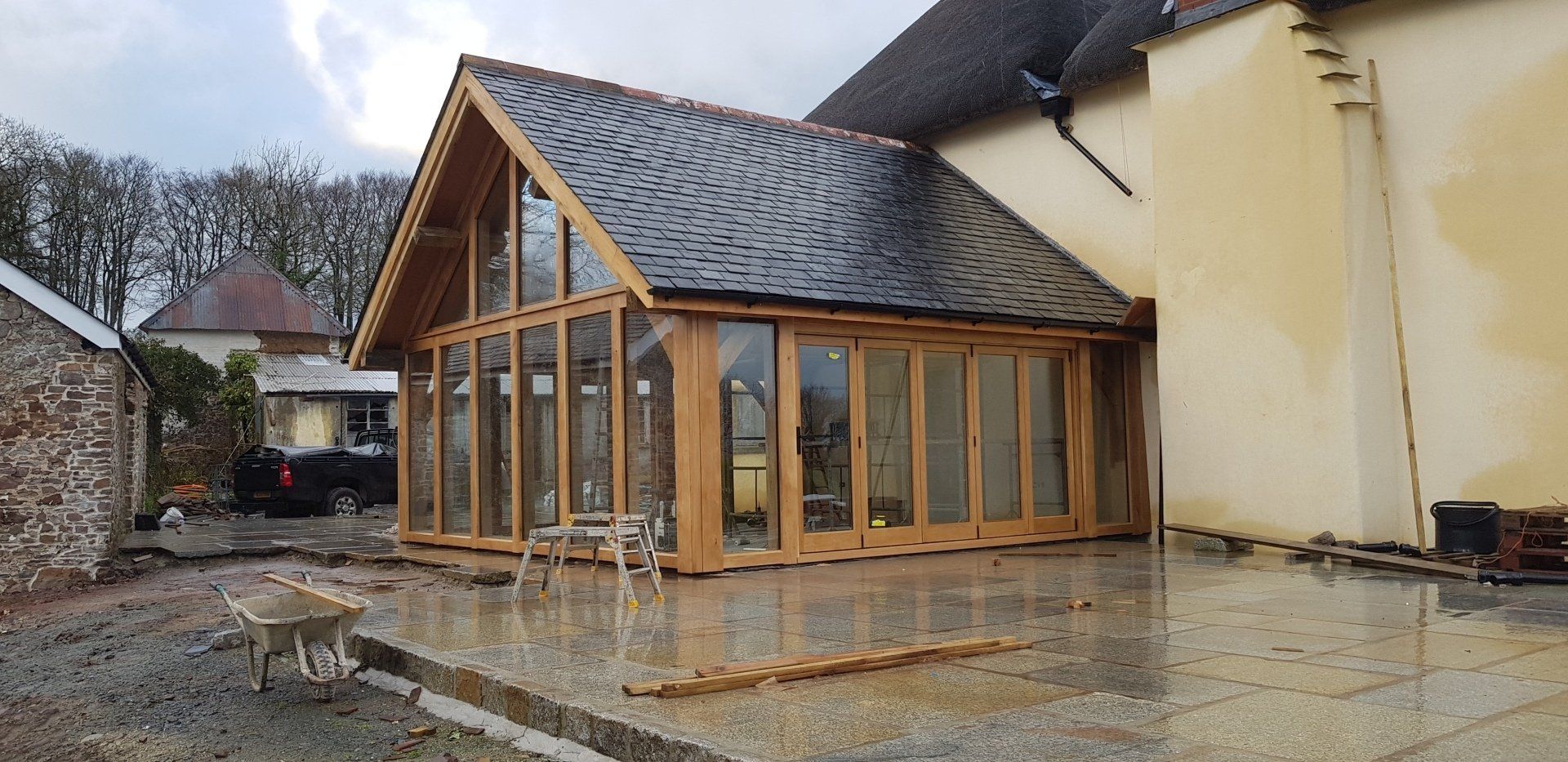 European oak Bi folds with 5 folding 1 way fitted in an oak framed building and double glazed with oak cover boards