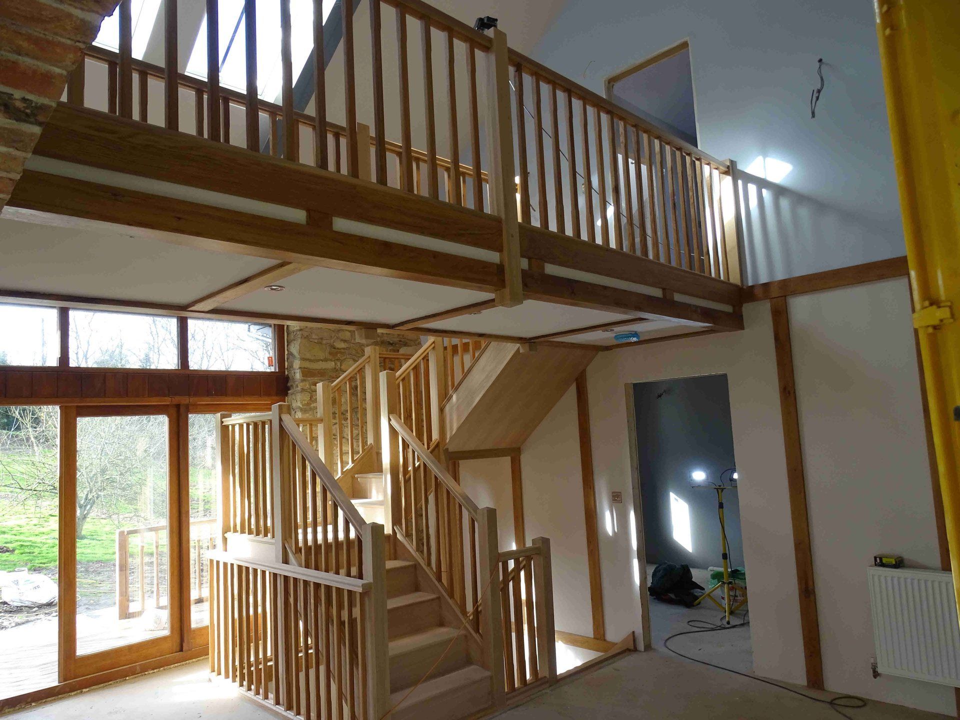 Oak staircase with double sided mezzanine walk wa Oak staircase with double sided mezzanine walk way in a devon barn conversion