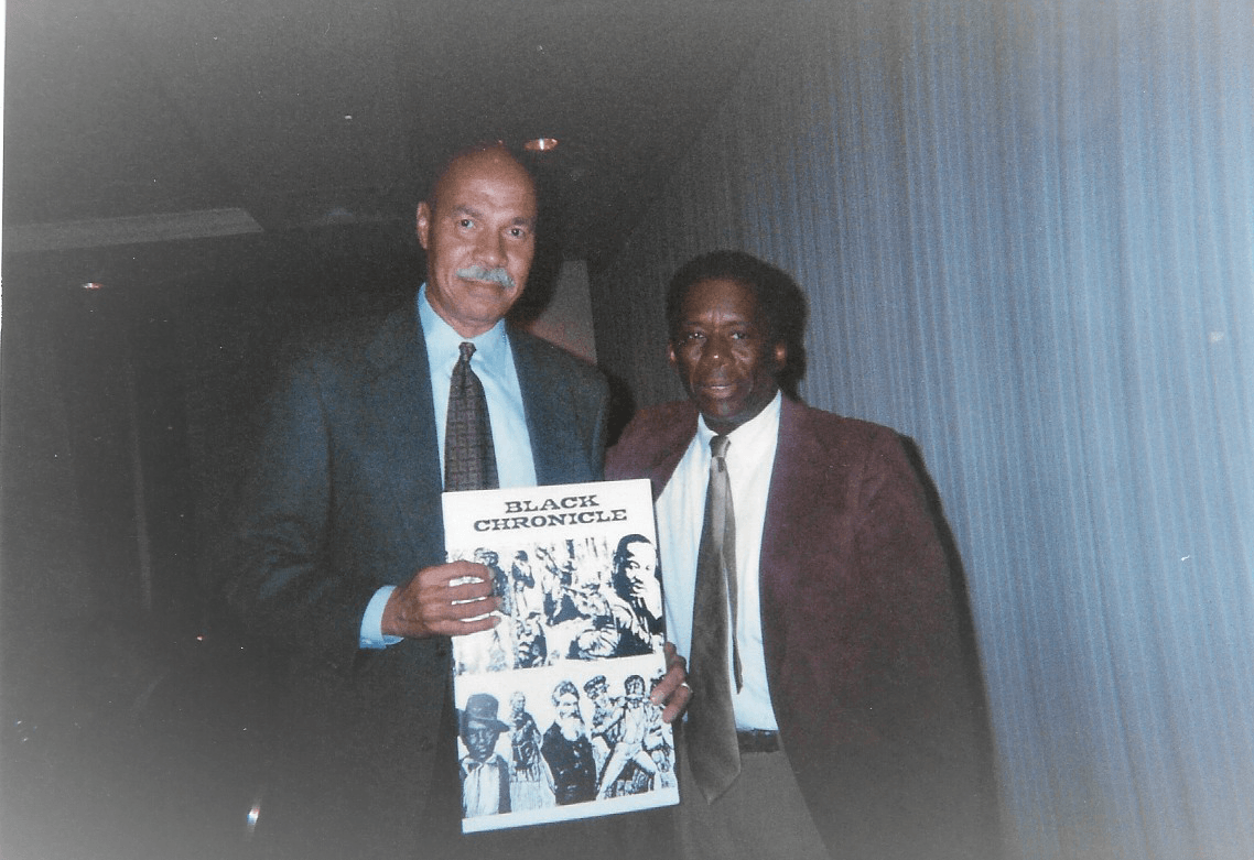 Rev Jesse L. Jackson with friend Ben Wilson holding Black Chronicle