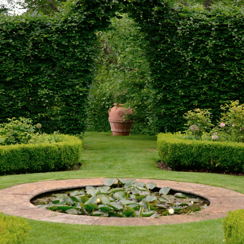 Traditional formal rose garden and pond