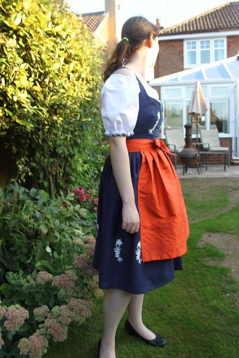 Girl wearing an octoberfest dress made by G Hughs and Son