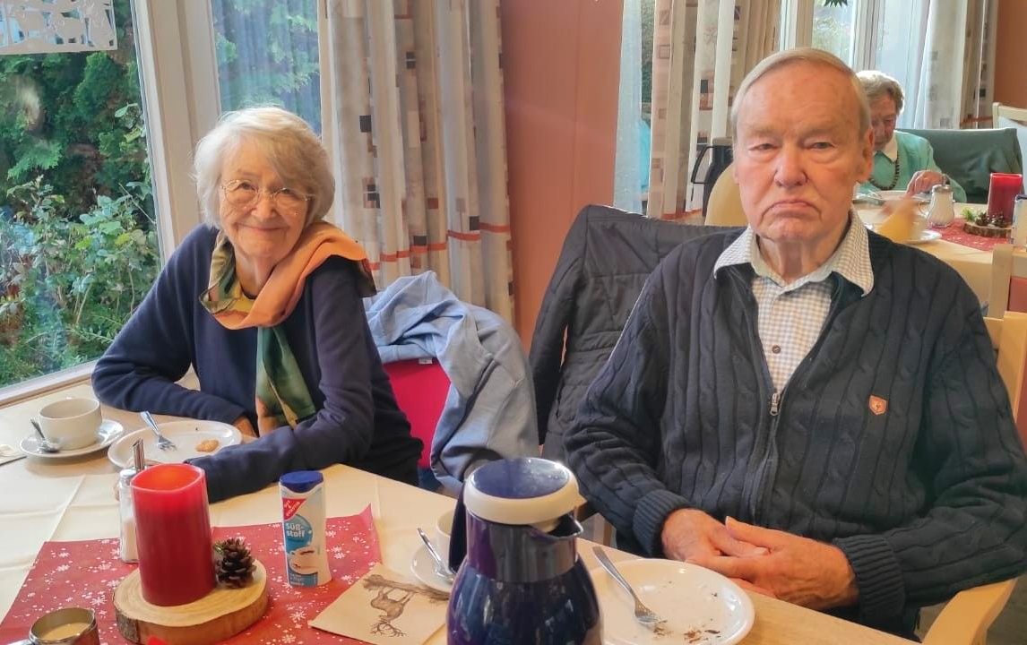 Senioren sitzen bei Kaffee im Speisesaal.