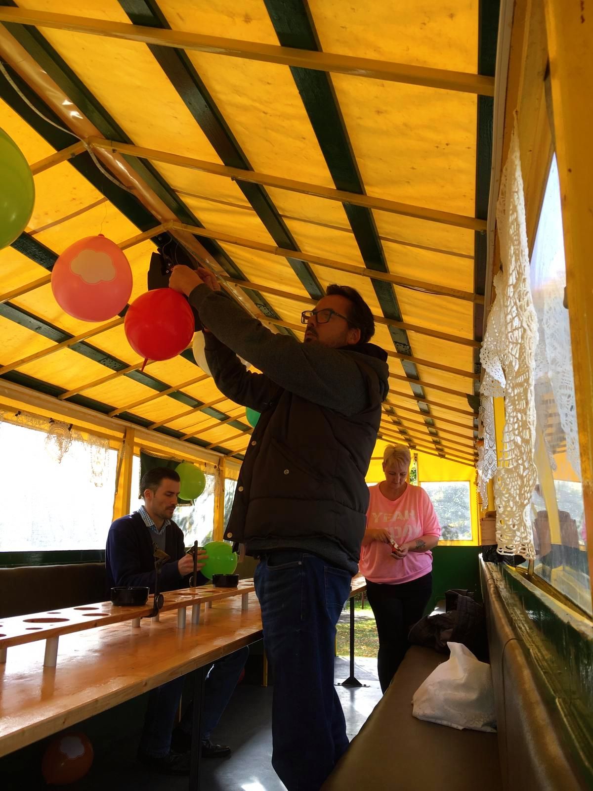 Mitarbeitende dekorieren den Festwagen des Lambertistifts mit Luftballons für den Kramermarktsumzug.