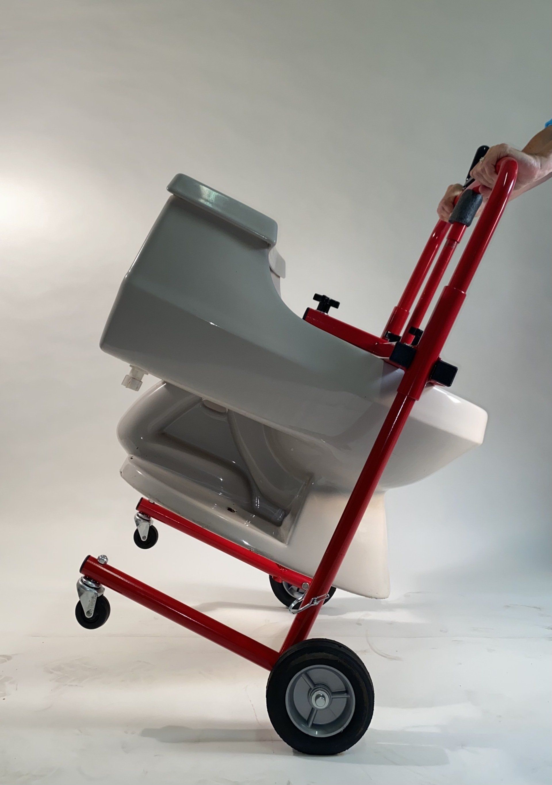 Tip TK400 toilet lifter tool back on to wheels to roll over uneven surfaces.
