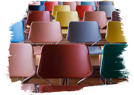 Kinder liegen auf dem Bauch auf einer Wiese mit ausgestreckten Armen und Fingern