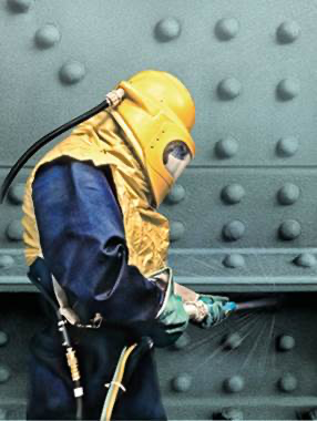 Man-in-protective-clothing-measures-surface-profile