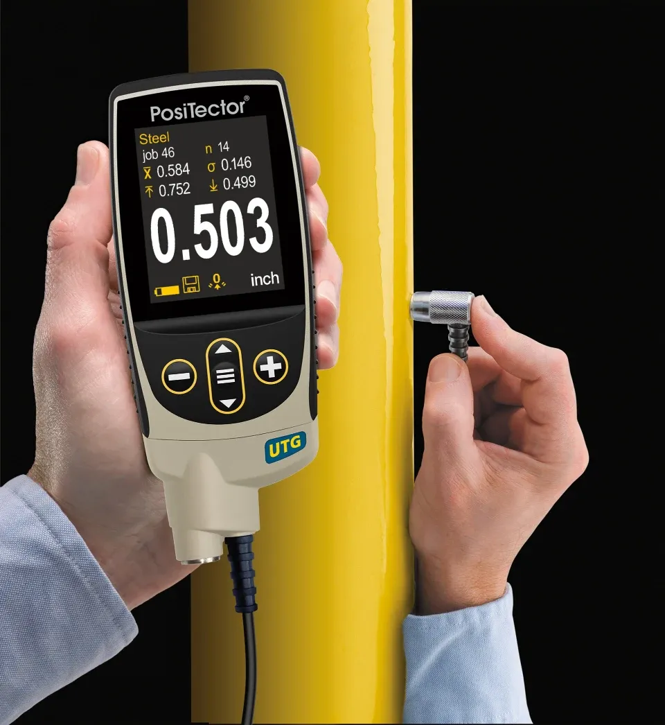 PosiTector UTG misst auf korrodiertem Rohr PosiTector UTG M misst gelb lackiertes Rohr