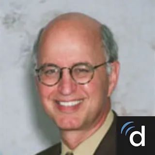 photo of smiling man in glasses