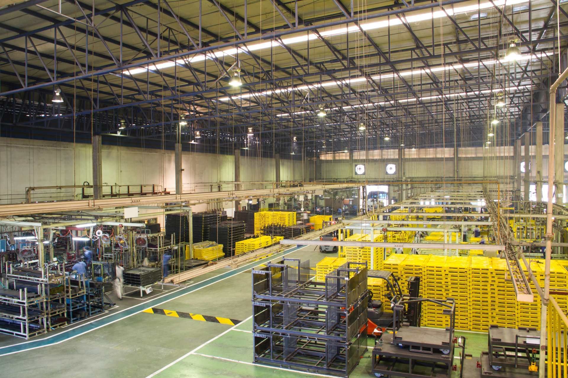 a an picking up a white shirt with red tie amongst blue ties