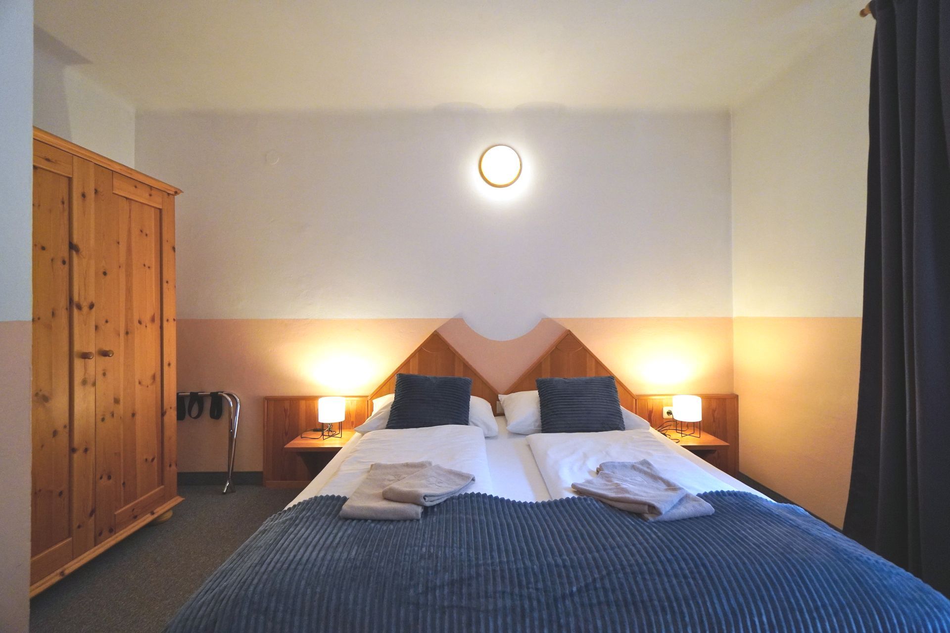 Apartment Hochalm Double bed in the bedroom, wardrobe