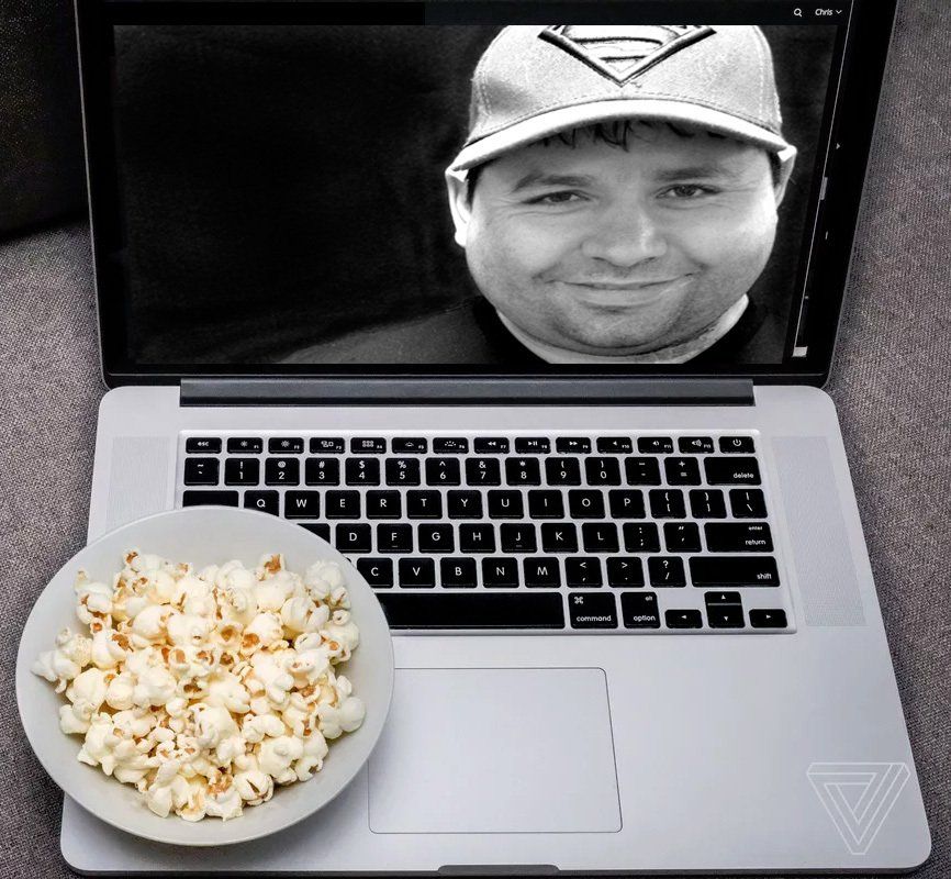 A computer showing faces of Tony and Garret with a owl of popcorn in the front