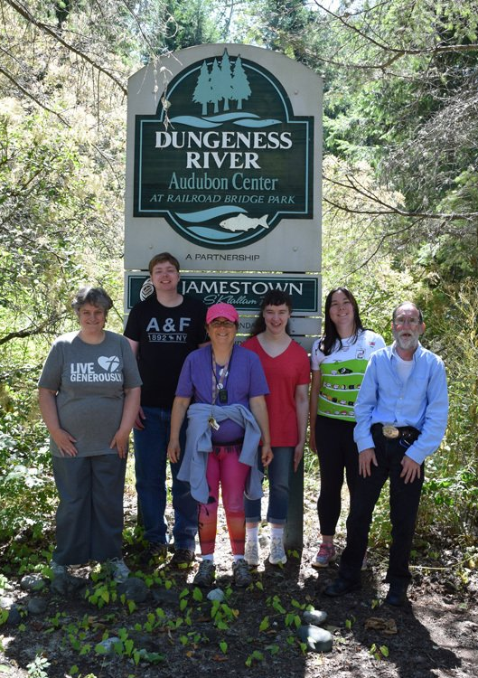 Group of individuals standing in front of the Dungenes River Audubon Center sign