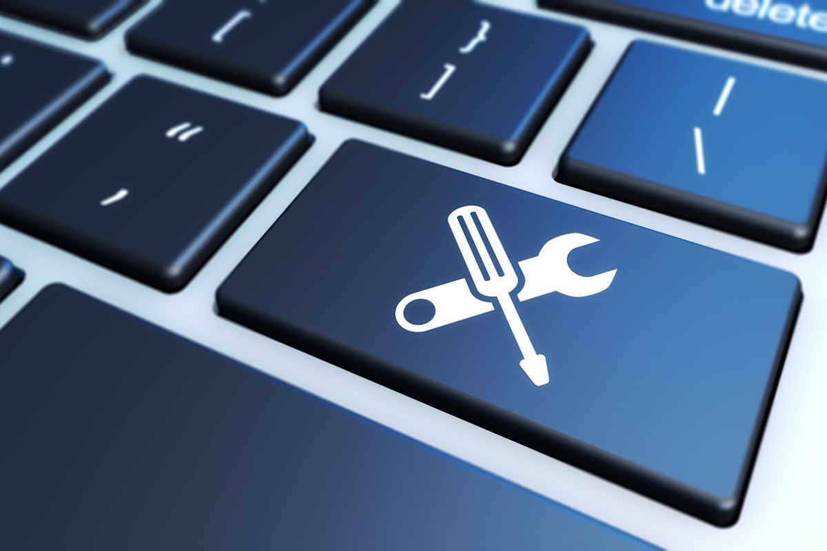 A Mac Keyboard with a unique key containing a screwdriver.