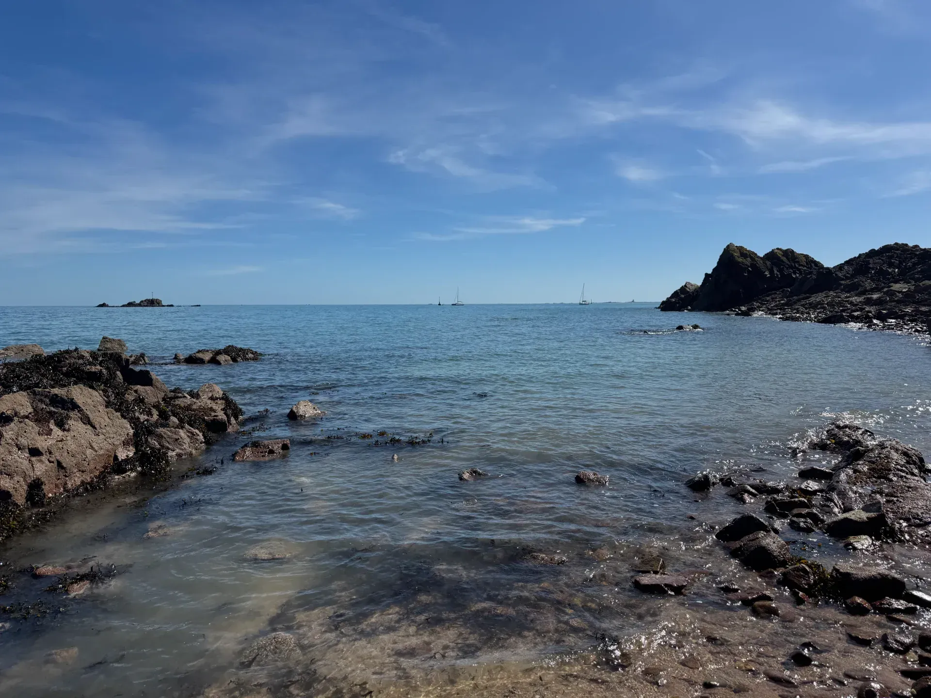 A beautiful beach in jersey with calm seas and blue sky