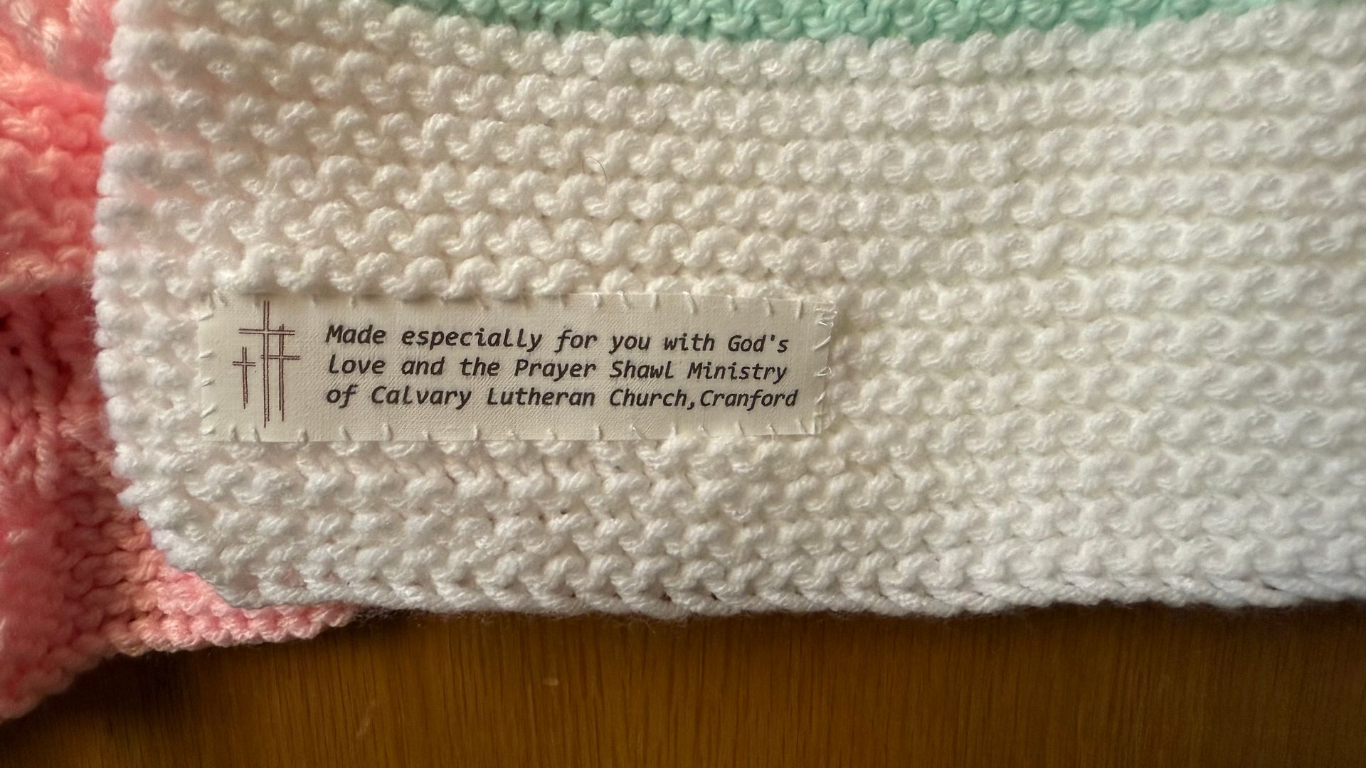 a close up of the tags put on our handmade prayer shawl. It reads made especially for you with God's love and the Prayer Shawl ministry of Calvary Lutheran Church, Cranford.