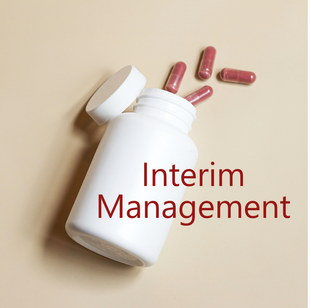 Geöffnete Medikamentendose mit Kapseln und dem Schriftzug Interim Management
