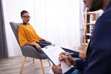a woman speaking with a counselor