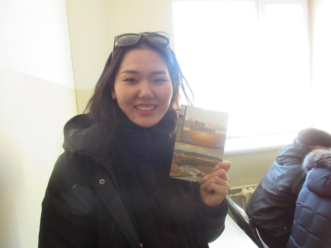 a worker holding a postcard