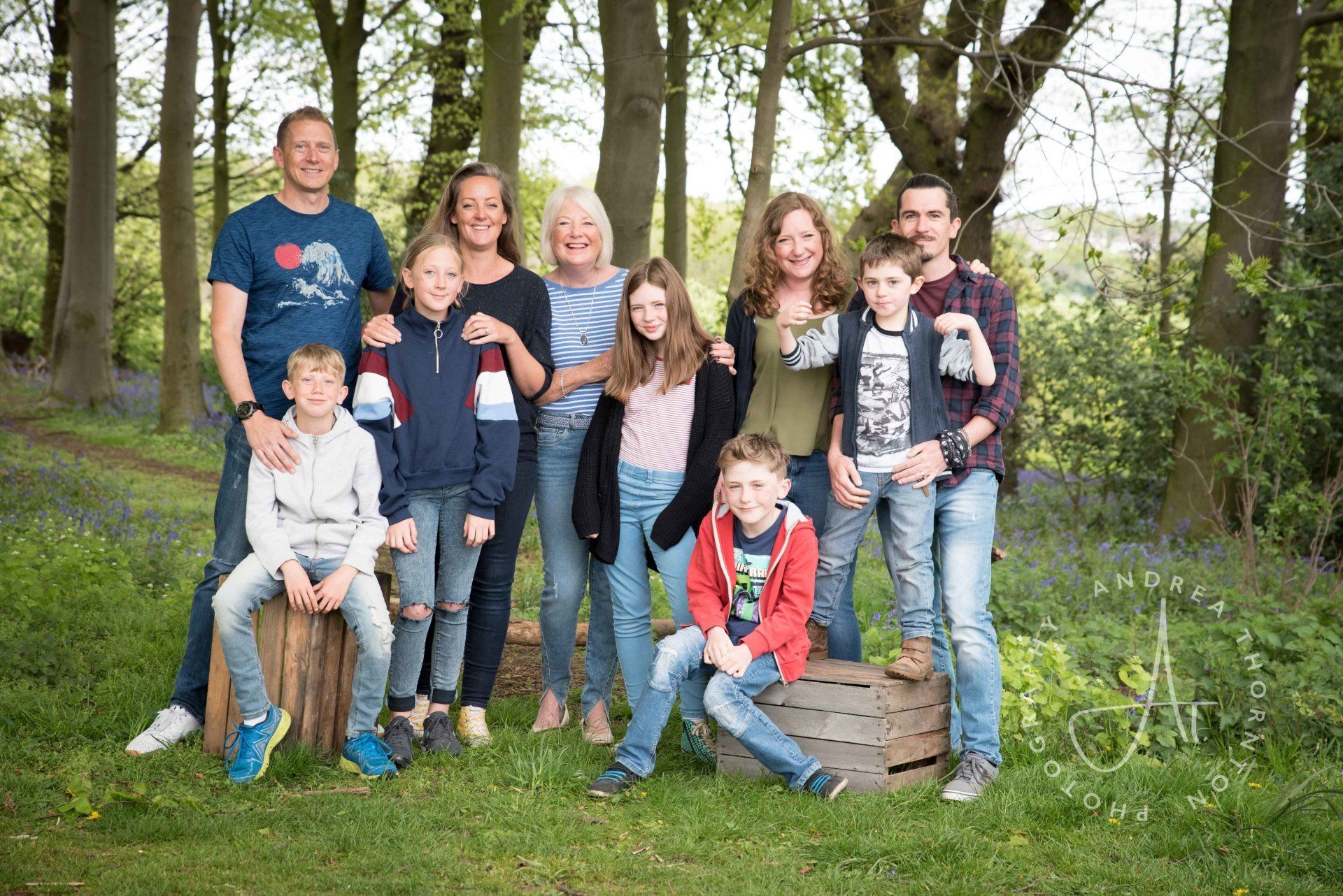 Large family group photograph in the bluebell woods