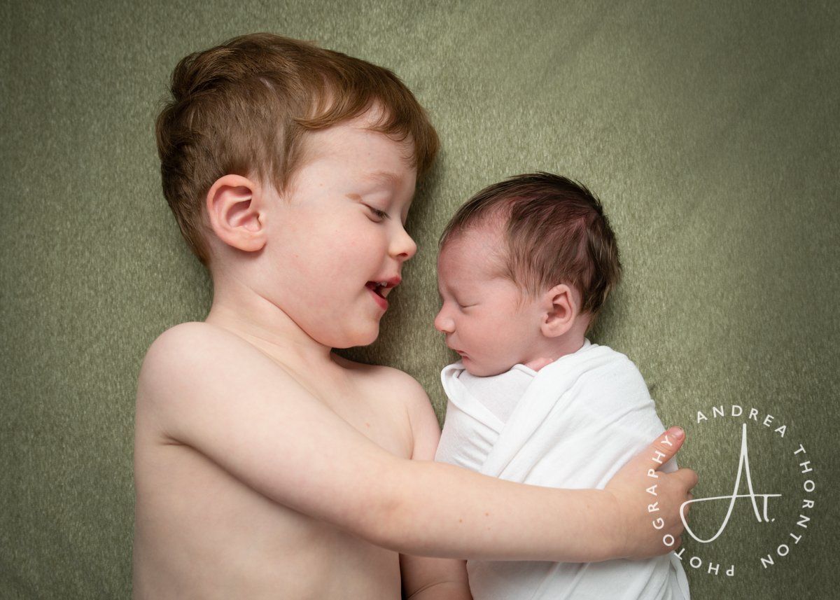 A newborn sibling photoshoot is a chance to capture adorable family portraits