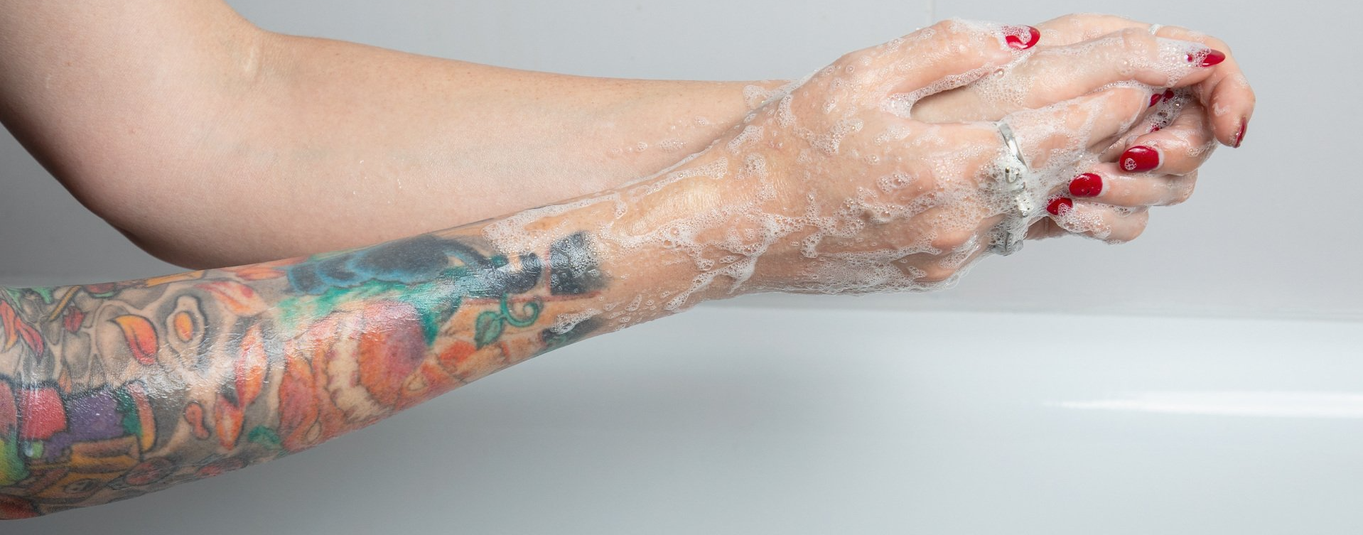 Tattooed model washing hands