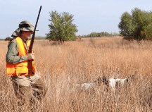 Hunter Walking in the Field with his Puppy Dog