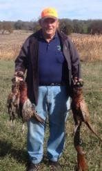 Hunter with his Pheasant and Shotgun