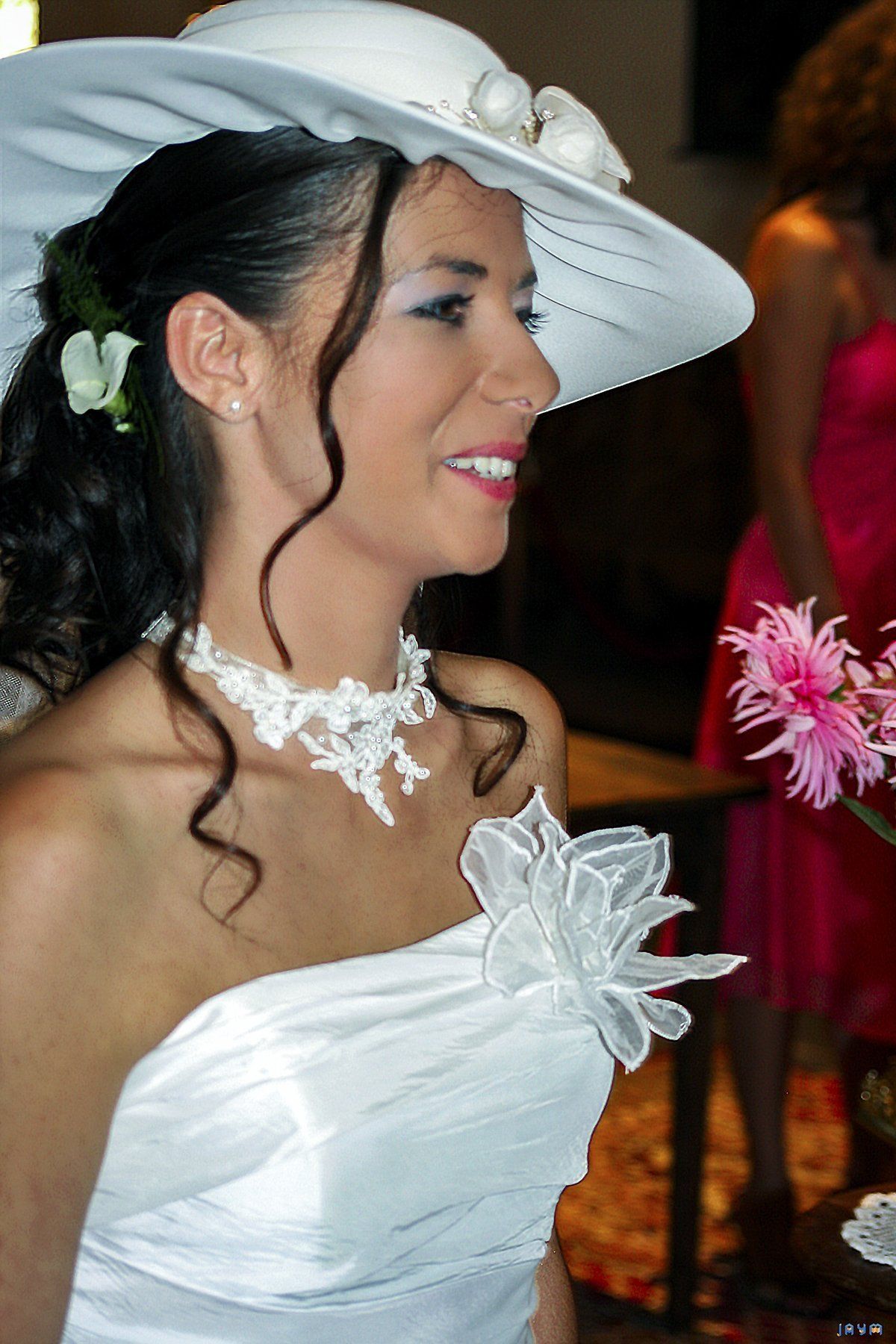 Héléna la mariée en belle robe blanche ornée d'une fleur en dentelle.