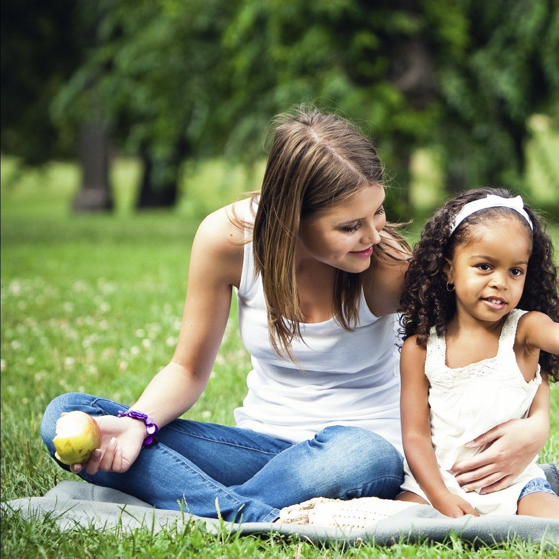 family having a picnic outside in the sunshine