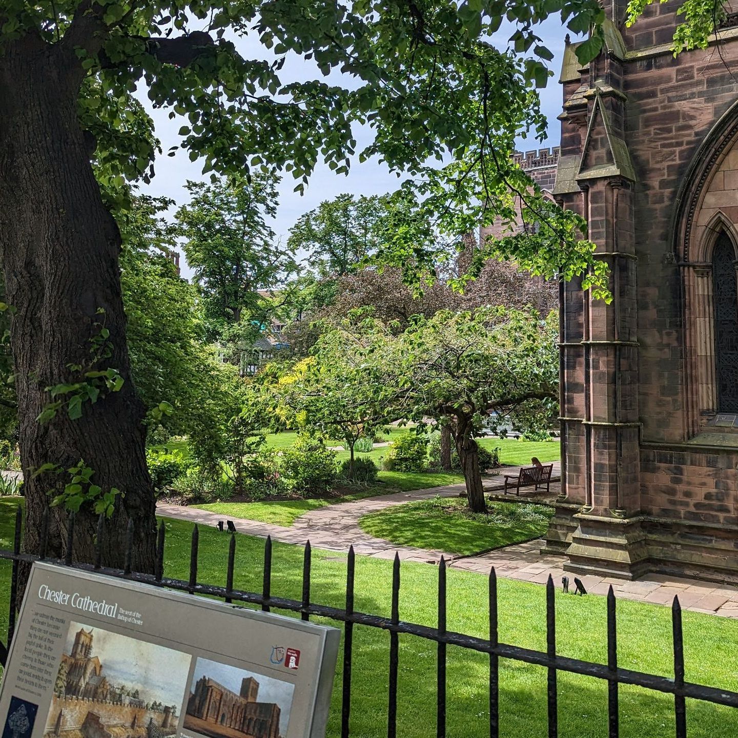 chester cathedral gardens with shady trees and flowers in bloom